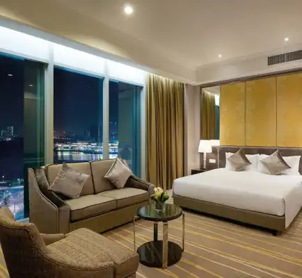 King bed and settee in a Dorsett Putrajaya Hotel room.